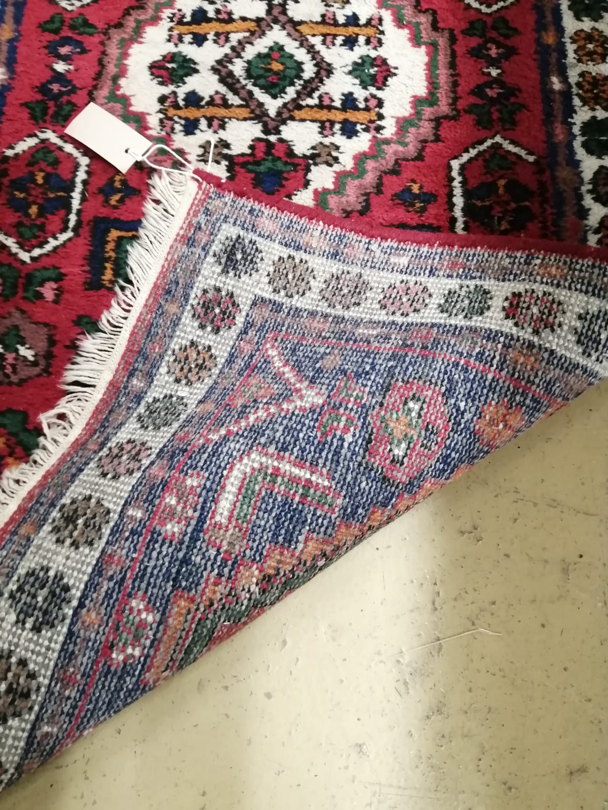 A Caucasian style red ground rug, 130cm x 68cm